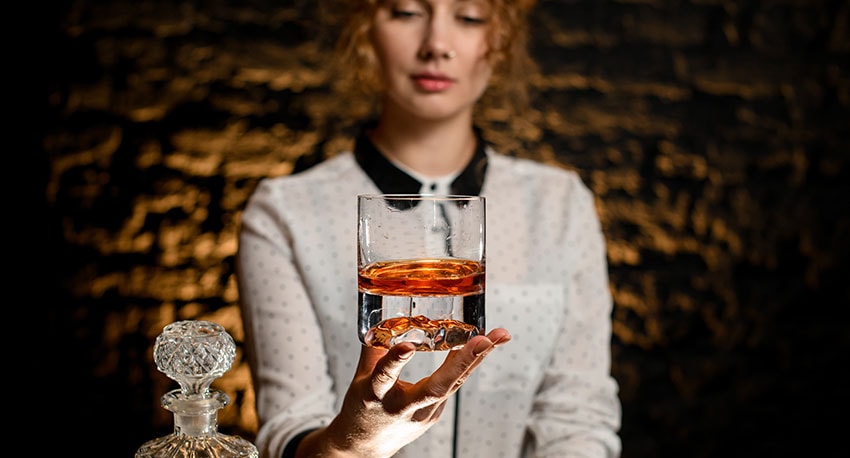 Woman holding a glass of rum