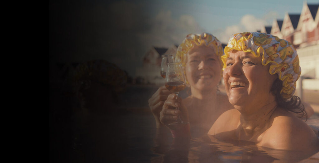 two women bathing with bathing hats